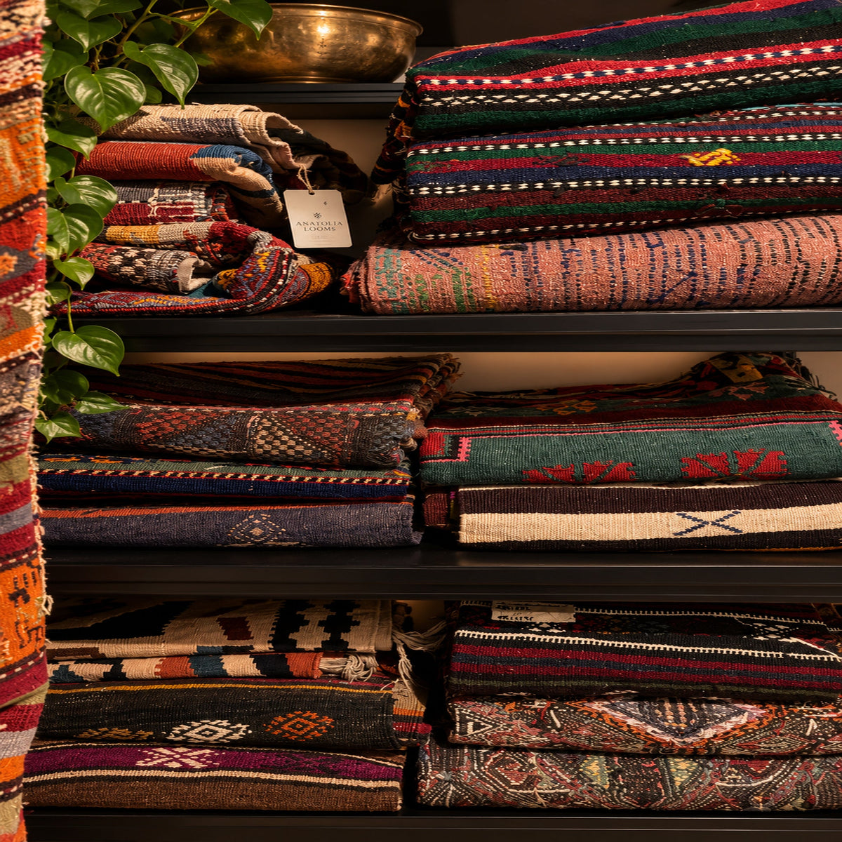 Shelves of vintage Turkish kilims and rugs at Anatolia Looms in Melbourne