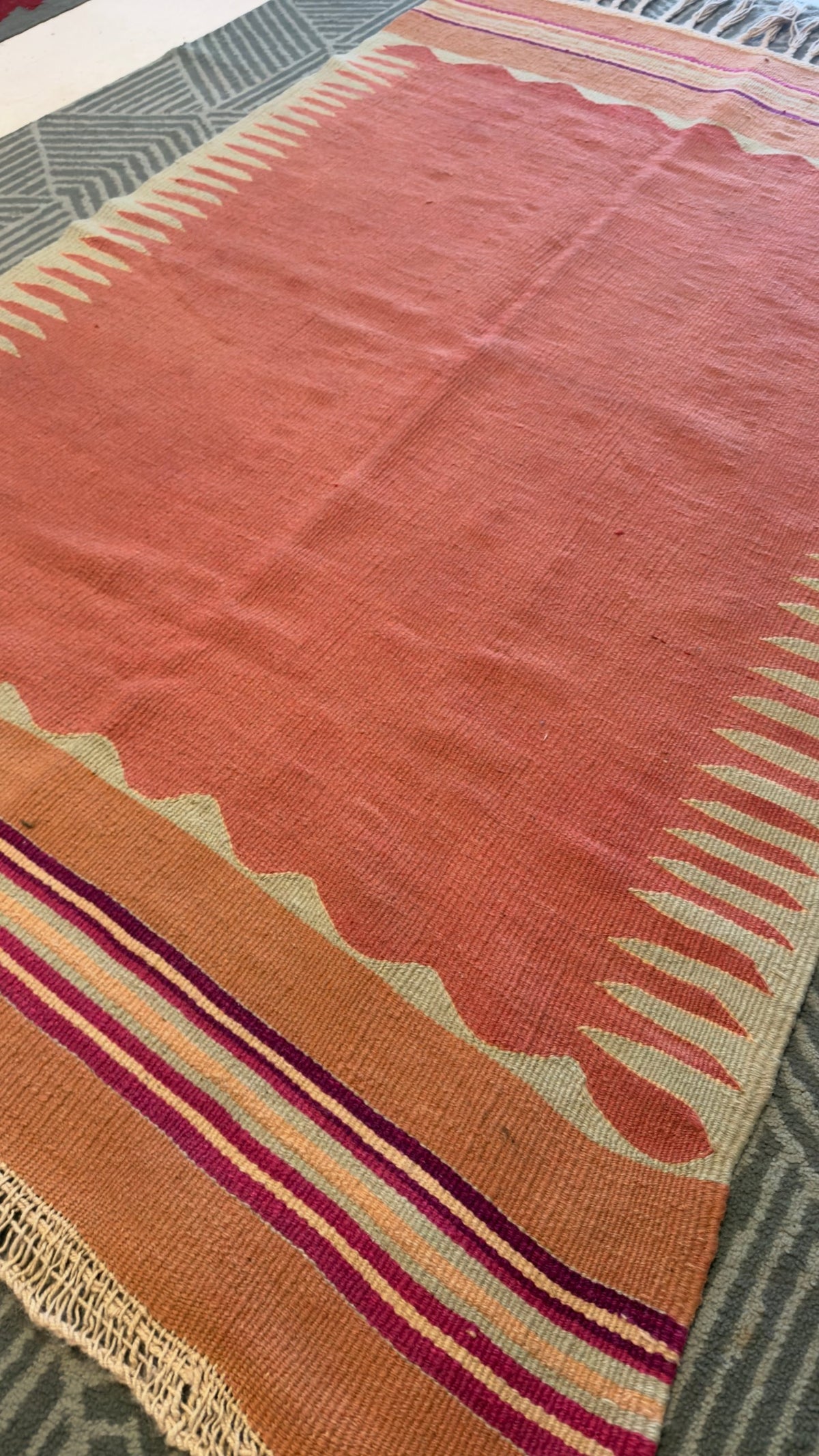Vintage Bodrum kilim in coral, striped end and braided fringe
